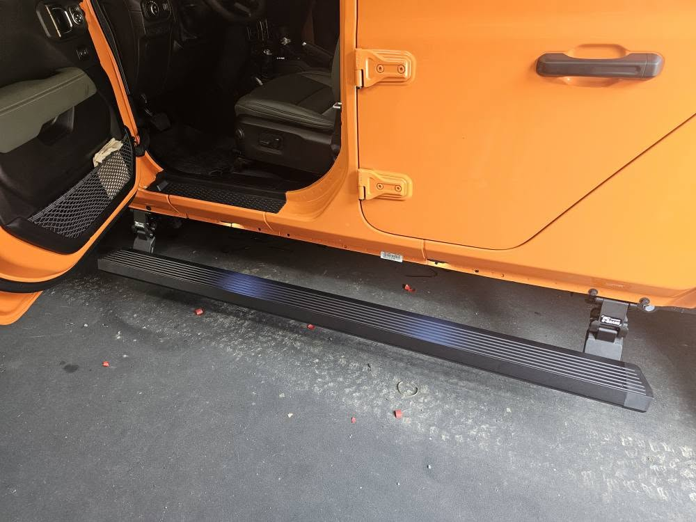 Power step on an orange Jeep
