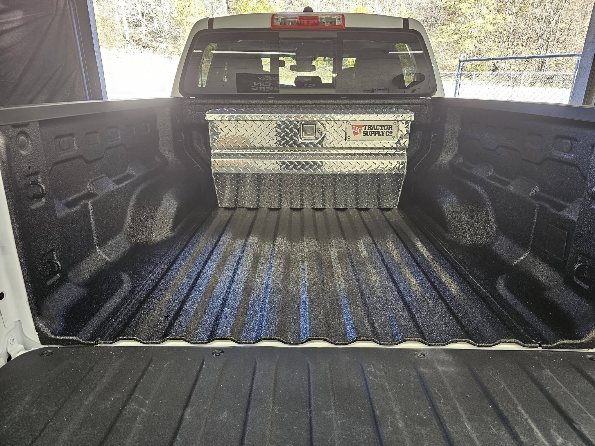 Spray-in bedliner in a pickup bed with a diamond-plate toolbox