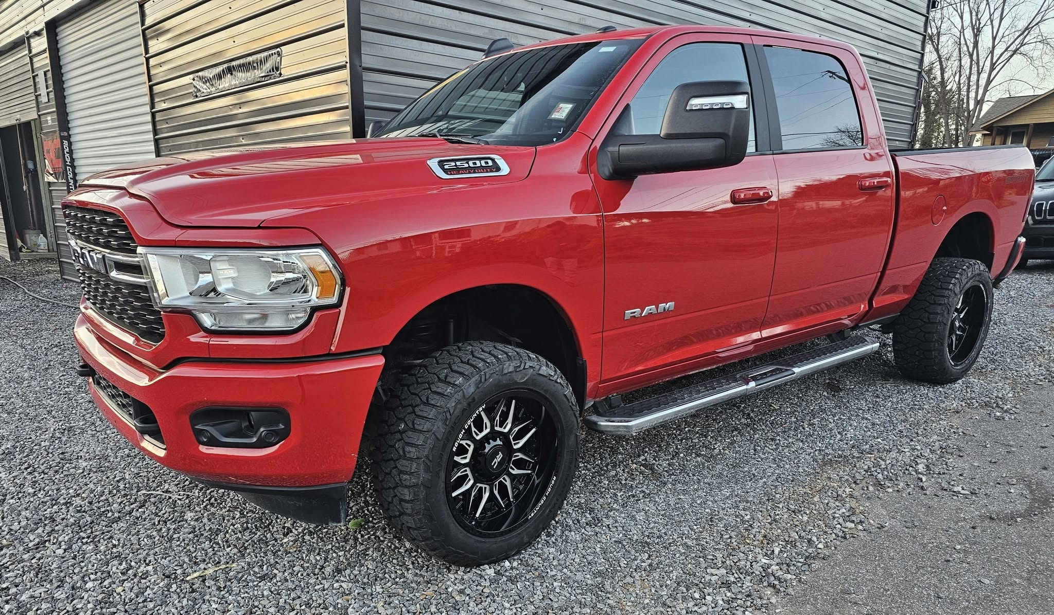 Red Ram pickup with aftermarket wheels and tires